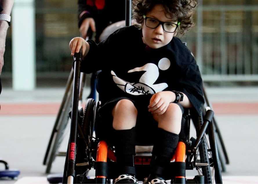 A child in a wheelchair.